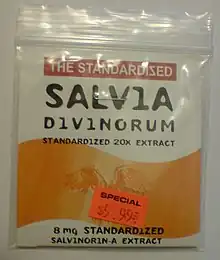 A rectangular plastic re-sealable zipper storage bag that appears to be approximately 10 by 15 centimeters. The bag has a white label and a large wavy orange stripe. The top of the label reads: "THE STANDARDIZED SALVIA DIVINORUM" in large letters and "STANDARDIZED 20X EXTRACT" in smaller letters immediately below. The bottom of the label reads "8 mg STANDARDIZED SALVINORIN-A EXTRACT" in small letters. Affixed to the bag is an orange price tag reading "SPECIAL $5.99."