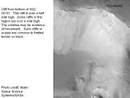 Steep cliff in Ismenius Lacus quadrangle with smooth mantle covering its face.  Picture taken under MOC Public Targeting Program.