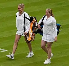 Clijsters walking onto Wimbledon Centre Court with Steffi Graf.