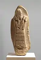 Stele with inscription showing the protectrice deity Lam(m)a, dedicated by king Nazi-Maruttash to goddess Ishtar, from Uruk (1307-1282 BC). Metropolitan Museum of Art.