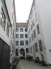 The first courtyard with the rear side of the building fronting the street