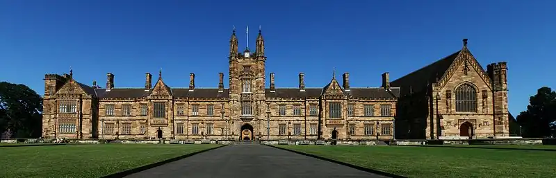 Photo of the facade of Sydney University on a bright morning. The building is described in the text.