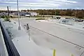 View of bus stops and parking lot from rail platform.