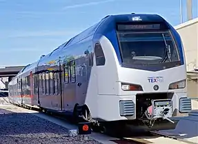 Trinity Metro TEXRail FLIRT3 arriving at DFW Airport/Terminal B station, 2019.