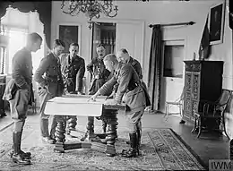 Photograph of a group of officers looking at plans on a table