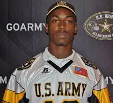 American football player in a hat and jersey both with US Army insignia.