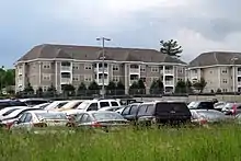 Three-story apartment buildings and a parking lot