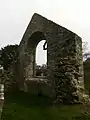 Ruined medieval church, with tracery fragment visible in the windowframe