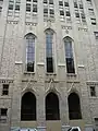 Traces of the Temple Methodist Episcopal Church include the original three entrance doors and decorative windows, designed in the Gothic Revival architecture style