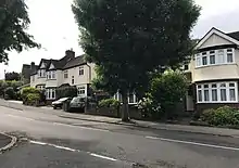 A view of The Charter Road from the green between it and Henry's Avenue, showing semi-detached houses in the Highams Estate