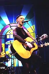 O'Riordan onstage with a large acoustic guitar