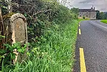 The Milestone on the road by Parke's Castle, indicating 7 miles to Sligo and 5 miles to Dromahair.