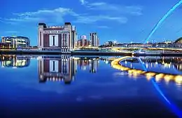 A warehouse signed "Baltic Flour Mills" surrounded by modern buildings.