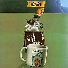 The front cover artwork of the album. A white coffee mug with the word "Arthur" and a picture of two men sits in the foreground; a sepia-tone profile photo of the Kinks sits behind it; a swan and other small, various objects sit behind the photo. A hand raises a flag from behind the pileup, which reads "The Kinks". These objects sit on a green background, with the exception of the top border, which is covered by storm clouds.