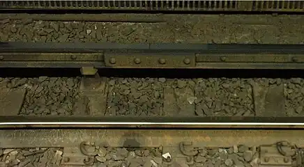 Conductor rail on the MBTA Red Line at South Station in Boston, consisting of two strips of aluminium on a steel rail to assist with heat and electrical conduction