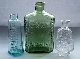 An empty bottle of True Daffy's Elixir (center) Dicey and Co.