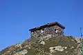 Stone mountain hut at the pass