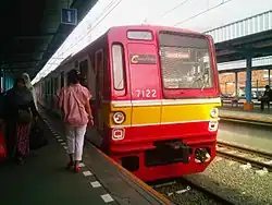 Red electric train at an outdoor station