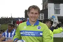 Young smiling white man enters a sports field