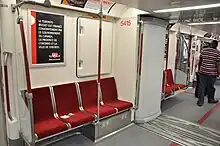 Gangway between cars. The poster, in French, when translated into English, reads "The Toronto Rocket is jointly financed by the Government of Canada, the Province of Ontario, and the City of Toronto."