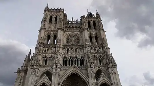 The flamboyant north tower (c. 1406) and the south tower (c. 1366)