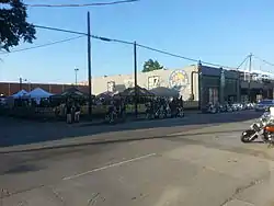 Building in downtown surrounded by motorcycles and tents