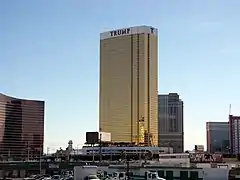 Ground-level view of a building with a rectangular cross section and a golden glass facade