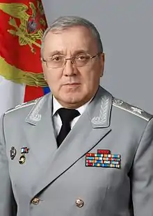 Ruslan Tsalikov in a grey dress uniform