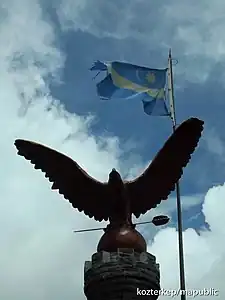 Turul statue with a Székely flag near at the peak of the Madarasi-Hargita (Harghita-Mădăraș), the holy mountain of the Székelys (1801 m) in Transylvania, Romania