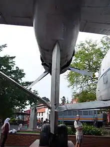 Plane undercarriage, with railway carriage beyond