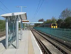 Platform on Hucknall branch with train passing