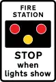 Fire station ahead, STOP when lights show. "FIRE" may be varied to "AMBULANCE"