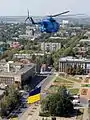 A Mil Mi-14PL holding the Ukrainian national flag flying over Mykolaiv