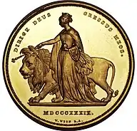 Gold coin showing a woman leading a lion