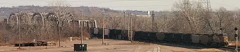 Coal train crossing the Union Pacific Bridge with the Loess Hills in background.