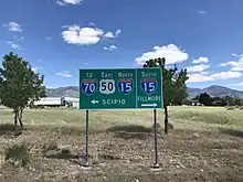 Signage at the T-intersection in Holden. To the right is SR-64, but the BGS simply points the way to Interstate 15 (May 2020)