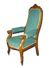 A Voltaire, which has a tall back and sometimes handles on the sides.