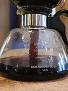 Step 6: As the glass carafe cools and the evaporated water contracts, the brewed coffee is pulled through the filter of the coffee ground container (by gravity and pressure difference) down into the glass carafe.