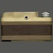 Back view of the camera, displaying the two-tone brown color and viewfinder.