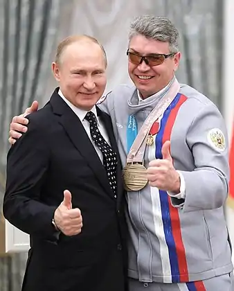 Valerii Redkozubov poses with a bronze medal along with Russian President, Vladimir Putin