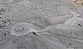 A bubble of gas bursting through the mouth of a Mud Volcano