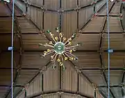 Painted wooden ceiling and bottom of chandelier