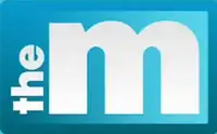 A light blue rectangle appears. Within it, white text appearing vertically and reading upward features "the" rendered in bold lower-case. Next to it, a thicker letter "m" in lower-case fills the remainder of the rectangle, thus reading to the eye as "the m".