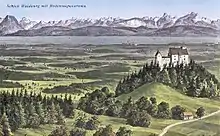 A medieval castle perched on a hilltop overlooks a broad valley, with a lake in middle background, and mountains on the horizon.