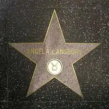 A five-point star set in the ground; the name "Angela Lansbury" is written in the centre of it in gold lettering