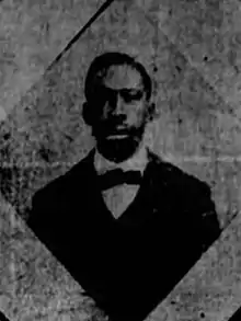 A black and white photograph of a black man in a suit and bow tie.