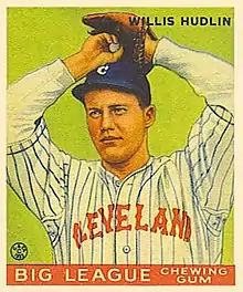 Baseball card image of a man in baseball uniform preparing to throw a pitch