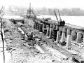 Construction of Wilson Dam taking place around 1919. Jackson Island, seen in the background, is now covered by Lake Wilson.