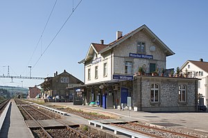 Three-story stone building with gabled roof