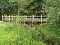 Footbridge on lower section of the walk, at Longford, by the Poolhouse Estate. It was modelled on the bridge on which A. A. Milne's characters played Poohsticks.